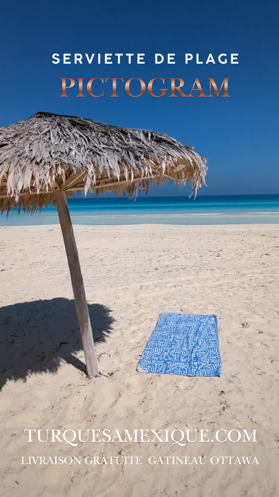 Beach scene with a straw umbrella and blue beach towel, featuring the brand TurquesaMexique.com